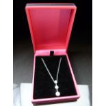14ct White Gold graduated diamond pendant necklace of approx .4pts on a gold chain.