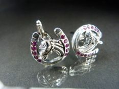 Silver and ruby set cufflinks in the form of horse shoes set with a horses head