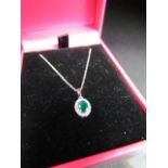18CT white gold emerald and diamond pendant necklace on gold chain cased approx 1/2ct