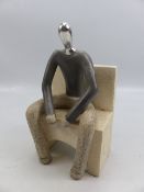 Stone figure of a man seated