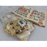 Selection of loose stamps and a stamp album