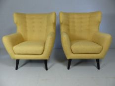 Mustard wingback modern armchairs by Made.com