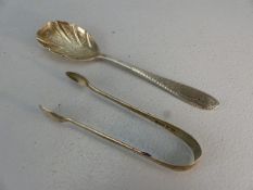 Pair of silver hallmarked sugar nips and a silver hallmarked fruit spoon dated 1897 maker G ? D F