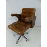 Large tan leather chair on chrome base