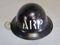 Military interest: one tin helmet black and marked "ARP" with original lining