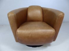 Mid century style tan leather and chrome based armchair.