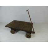 Antique wooden planked cart with metal wheels and handle