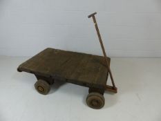 Antique wooden planked cart with metal wheels and handle