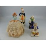 Three late 19th century staffordshire figures, and porcelain topped pin cushion in the form of a