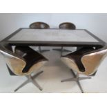 Modernist Industrial table with steel plated top and matching chairs. By 'The One'