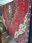 Red Ground persian tabriz carpet with floral medallion design.