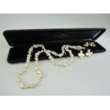 Fresh water single string of pearls approx 24' long with an approx 7.8mm 14k gold clasp. plus two