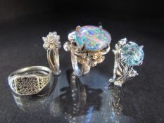 Three hallmarked silver rings and one other set with opal doublet