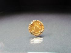 Chinese Gold Proof coin 5 Yuan .999 gold. Set in a gold coloured mount. Approx weight 2.5g
