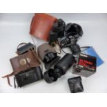 An Olympus OM10 35mm camera and a selection of lenses and binoculars