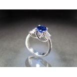 18K White Gold Diamond and blue stone ring. Central oval blue stone measures approx 7.76 x 5.91mm