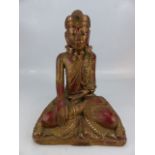 Seated wooden carved Indian deity with shell eyes and a rose necklace (H approx 35cm)