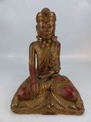 Seated wooden carved Indian deity with shell eyes and a rose necklace (H approx 35cm)