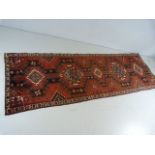 Red ground Iranian runner with medallion design