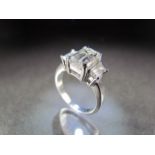 White Gold three stone Diamond ring. The Emerald Cut centre stone is approx 4ct, measuring approx