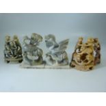 Three carved soapstone monkey figures in pyramids along with a crane soapstone figure.