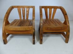 Unusual wooden pair of single armchair with sloped arms