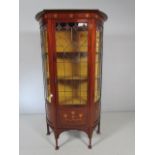 Arts and Crafts display cabinet with shaped front and sides. The top frieze panel inlaid with copper