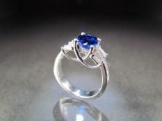 18K White Gold Diamond and blue stone ring. Central oval blue stone measures approx 7.76 x 5.91mm