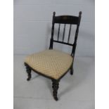 Antique Ebonised nursing chair with castor feet