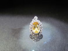 1920's Silver and marcasite pendant set with an oval cur Citrine