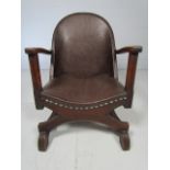 Low unusual shaped chair with X front support and reeded style legs. The seat and back both