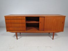 Teak Mid Century sideboard with 4 drawers to side and sliding cupboard.