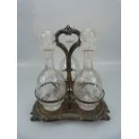 Antique silver plated three bottle decanter holder.