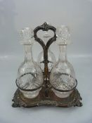 Antique silver plated three bottle decanter holder.