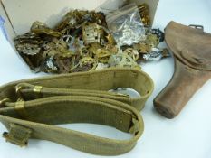 Large selection of cap badges, military gun belt and a gun holster