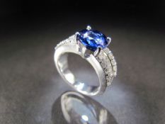 18ct (750) White Gold diamond and blue stone ring. Centre round blue stone measures approx 8.5mm