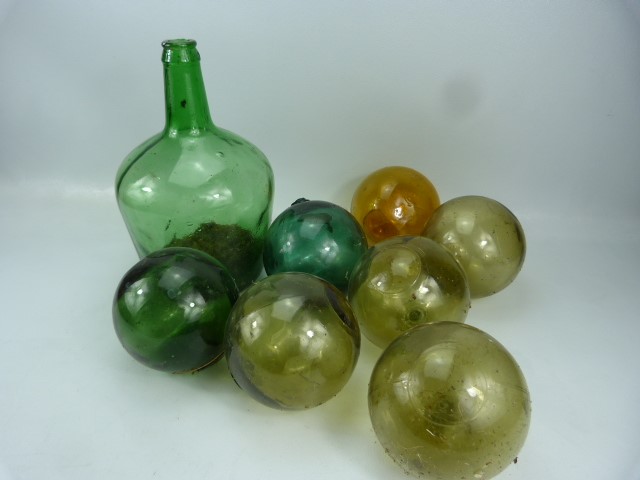 Green glass mallet bottle and a selection of glass buoys