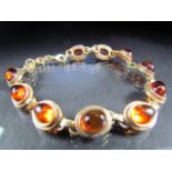 A silver Gilt bracelet with amber coloured stone