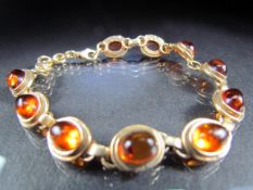 A silver Gilt bracelet with amber coloured stone