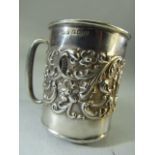 Hallmarked Silver tankard (6.3cm tall) embossed with flora with a small un-engraved cartouche,
