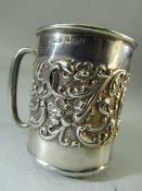 Hallmarked Silver tankard (6.3cm tall) embossed with flora with a small un-engraved cartouche,