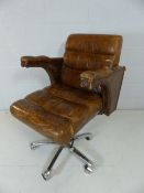 Large tan leather chair on chrome base