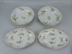 Royal Copenhagen set of bowls, decorated with yellow floral sprigs.