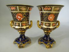Royal Crown Derby - fine bone china urns with gilded twin handles and fluted necks. 1A/F