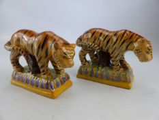 STAFFORDSHIRE - a pair of early 19th century Prattware Staffordshire Tigers. Both decorated with