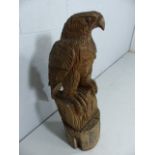 Carved Wooden eagle perched on stand