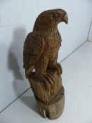 Carved Wooden eagle perched on stand