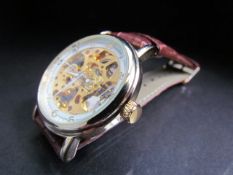 Gents skeleton watch with visible escapement on leather strap