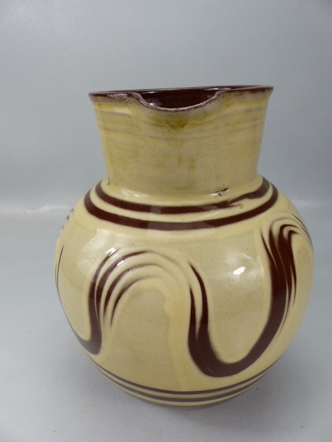 Large bulbous slipware glaze jug in cream and earthenware red. Marked to base L'Etacq, Jersey JW. - Image 3 of 5