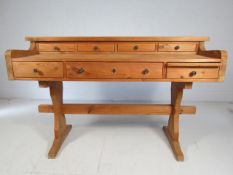 Unusual French pine writing desk over two tiers with multiple small drawers.